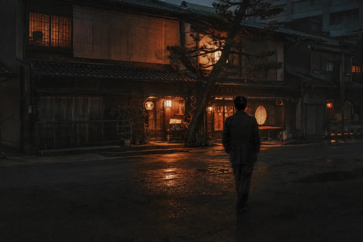 Eine Straße in Kyoto bei Dämmerung mit orangefarbenen Laternen.